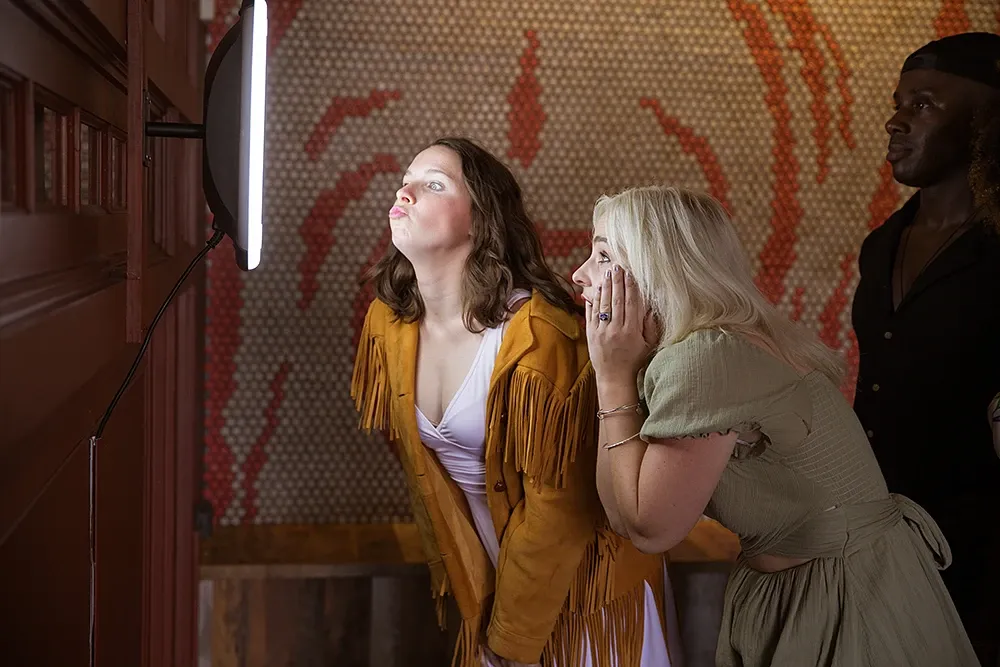 Guests taking photos with a Simple Booth photo booth at a bar